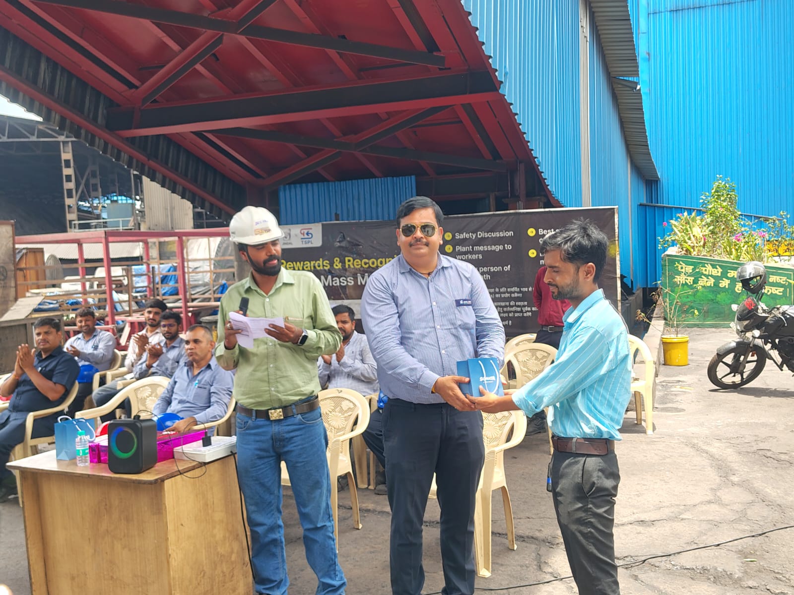 Speaker leads the briefing near the plant facility